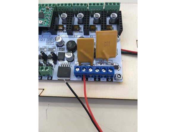 Insert wires from 12v power connector into terminal blocks ensuring that the red wire is inserted into the positive terminal and the black wire is inserted into the negative block