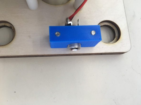 Slide the 12v power plug into holder.  Note that once side of the holder is slightly larger than the other.  It fits better the correct way around.