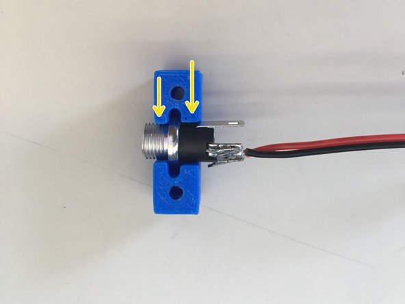 Solder the black wire to the north pole and the red wire to the west of the power connector following the same techniques used for the switches.