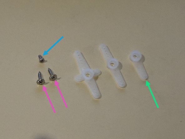 The servo package includes two identical largers screws.