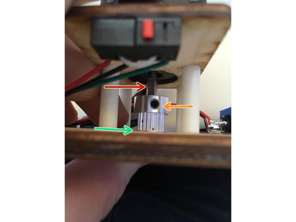 Slide a pully onto motor shafts.  Locate the flat side of the motor shaft.