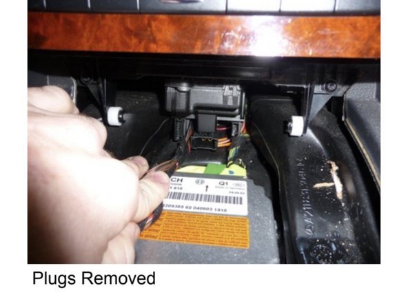 Remove (2) T-20 screws that hold the CD changer in place.