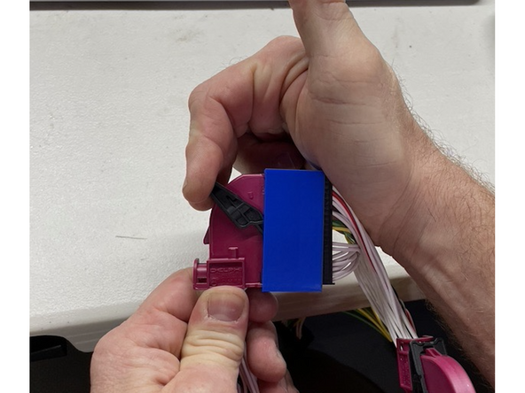 Unlatch and unplug 40-pin BLUE connector from top of EIS module