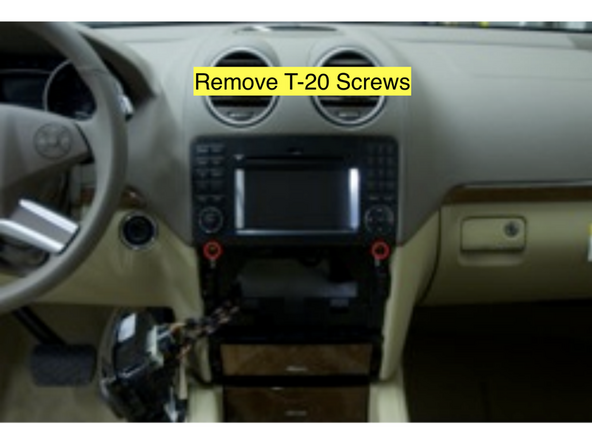 Locate and remove (2) T-20 screws from the aluminum bars showing just below the radio
