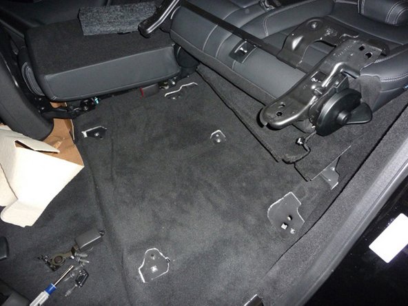 Flip the driver’s side rear seat back into the cargo area making sure the wire harness doesn’t get pinched or pulled beyond its limit.