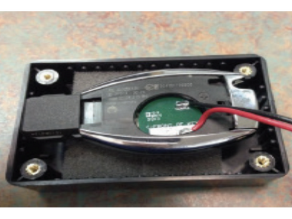 Remove the battery cover using the flat blade screwdriver by pressing on the tab inside the key