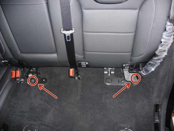 Remove one (1) bolt holding the center seat back bracket and (1) bolt holding the seat belt.