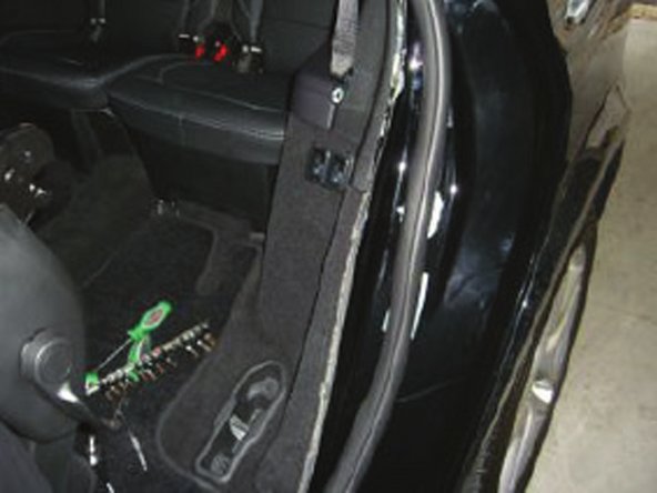 Pull back weather strip on the back side of the rear door opening.