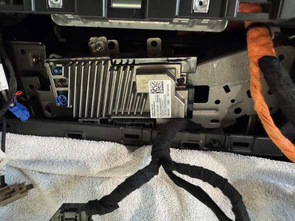 There is a bracket holding both the radio control module and the gateway module. Remove bracket and pull both modules from dash cavity