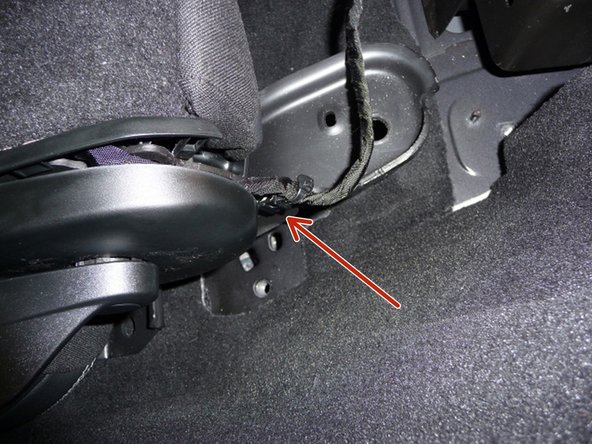 Un-clip the wire harness that is clipped to the driver’s side rear seat bracket.