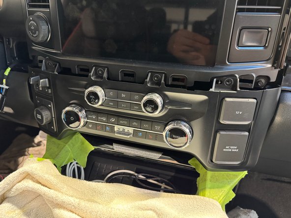 Release bolster panel on left side of controls