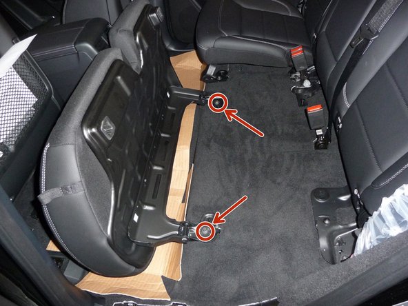 Remove two (2) bolts holding the seat bottom to the floor.