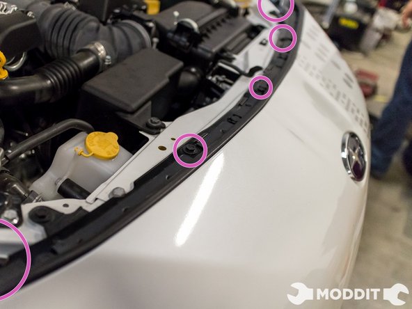 Now turning our attention to the top of the bumper, we will have to remove the five bolts up top with a 10mm socket.