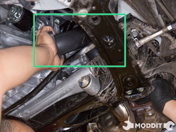 We start out by maneuvering the over pipe over above the sub frame and steering rack.