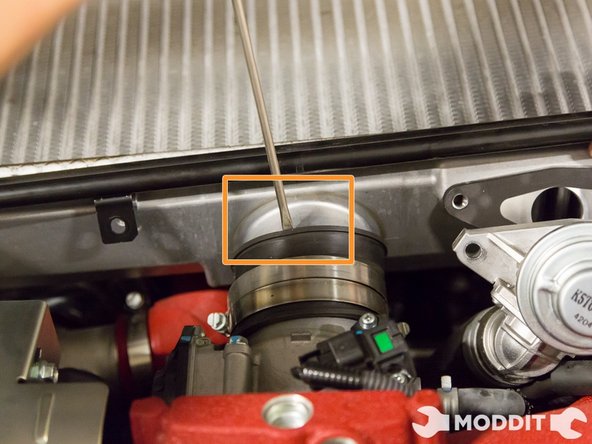 You can use a 90deg pick and run it around the outside edges of the coupler help free it