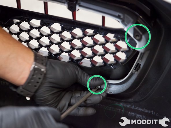 Use the correct sized phillips screw driver and start removing the screws that hold that grille into the bumper.