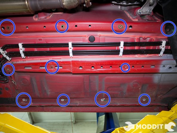 After removing all the sound dampening clips and OEM left/central under tray, this is what that area should look like. Visible here are also some of the holes we have marked for the install. Not shown are the sections closest to the front and back.