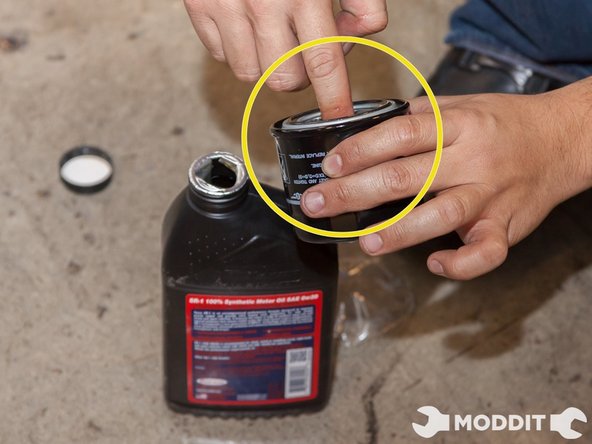 We then began to prep the new filter. We got some of the used oil (or you can use the new oil) to lubricate the new one and ensure a secure seal. Next we simply hand tightened the new filter as only 10.3 ft-lb of torques is needed to secure it on.