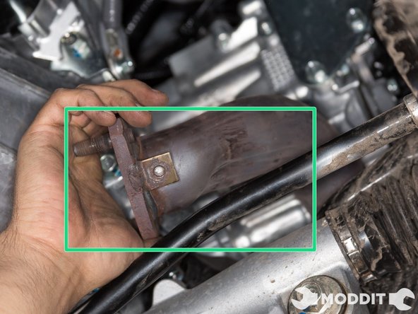 With the heat shields removed, you may now maneuver the overpipe forward and under the header.