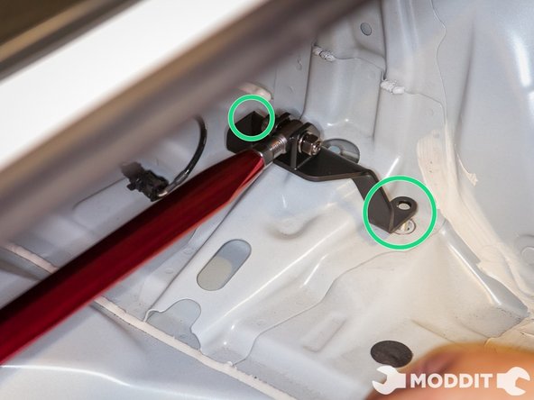 In these images we already had the bolts removed and were placing the strut bar ends onto the strut bolts.