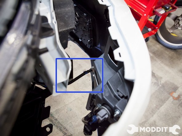 Then pull from the front, but not all the way as the lights are still connected.