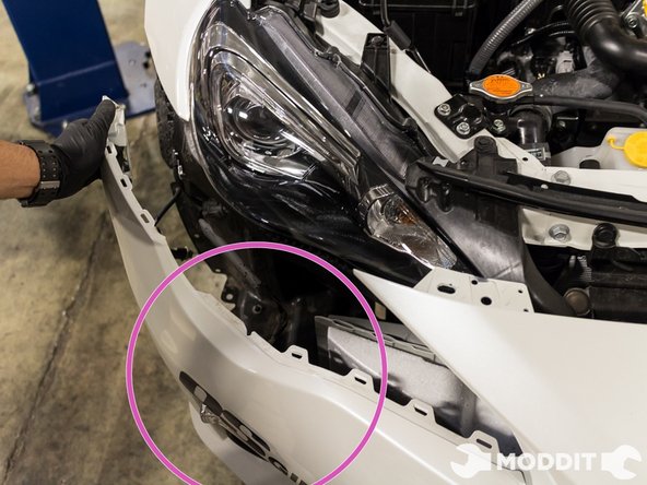 After the top fasteners have been removed, the front bumper can now be pulled firmly from the vehicle.