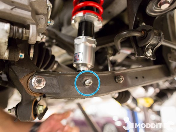 After you have the shock in the control arm, go ahead and line up the holes. (a pick or screw driver can help lining them up)