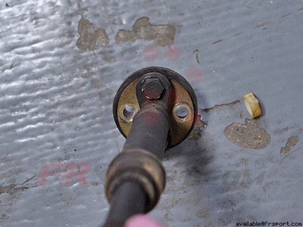 The Bushing is still held on by two more 12mm nuts on the opposite side connected to the two black bolts we mentioned earlier.