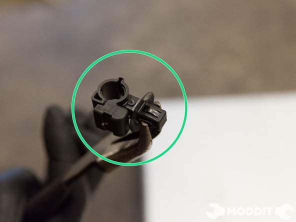 After you manage to take the strut off, remember to also remove these clips with pliers from the strut housing in order to reuse them on your coilovers. We almost tossed them before we realized we needed them. They are quite small and easily forgettable.