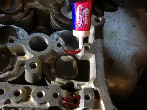 11)    Installing the cam. Inspect cams to be clean and clear of all debris and burs. One will be labeled “IN” and the other will be labeled “EX” so be sure to note which is which. Lubricate the cam carriages where the cams sits with assembly lube. We used Torco MPZ Engine Assembly Lube. A 0.5oz will be more than enough.