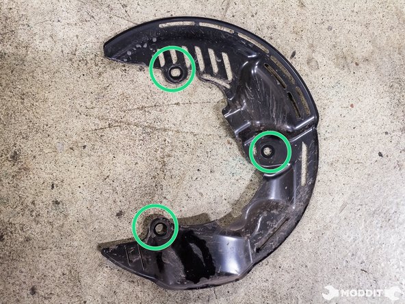 Using a 12 mm ratchet tool, remove the three bolts securing the dust shield to the knuckle.