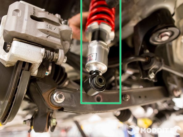 Since the coilover did not fit the normal way, we hung the coilover from the strut tower. Basically putting the top hat bolts through and threading the nut a bit on there afterwards.