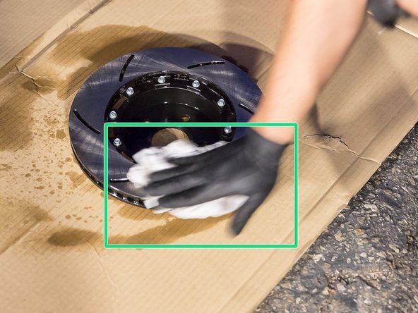 Spray brake cleaner on the rotors and wipe with paper towel to get rid of all the oil residue.