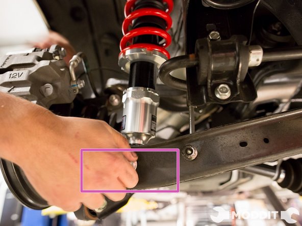 Once you think the hole is lined up, shove the pointed tip bolt that was taken out from the stock shock earlier.