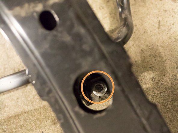 Using a 12 mm socket, remove the nut found on the bottom-side of the u-shaped bracket, also securing the sway bar to the Chassis/Sway Bar support bracket
