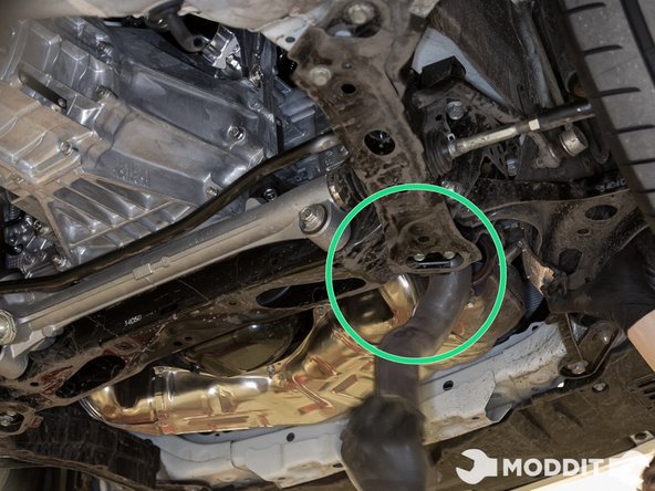 With the heat shields removed, you may now maneuver the overpipe forward and under the header.