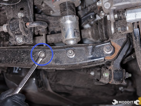 With a 14mm wrench, remove the sway bar end link to lower control arm bolt.