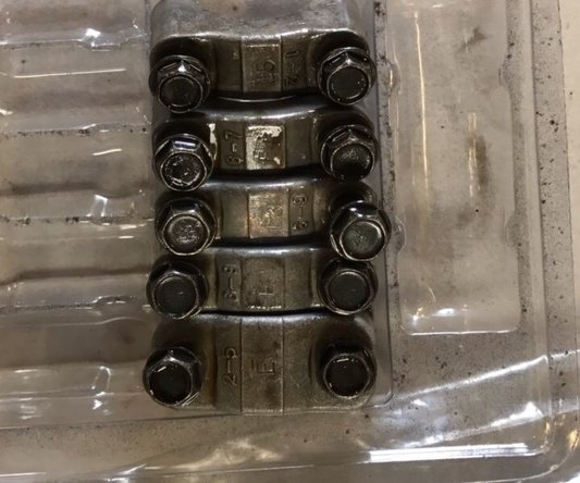 With the sprockets removed or pulled to the side, Begin to mark the cam caps. Many times they will already be marked with and “I” or an “E” followed by a number to indicate their location. We like to add that extra bit of insurance by actually marking them or at least removing and placing them in a container that will display their placement.