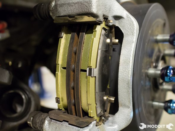 With the pads and shims assembled, install them into the brake caliper bracket.