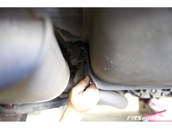 Next, unbolt the midpipe from the hanger bushing it is screwed into.