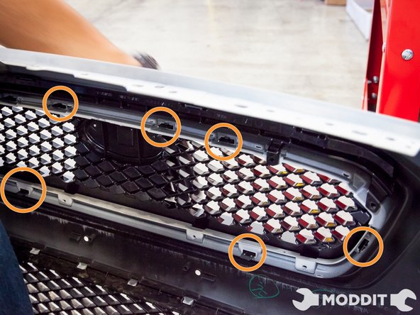 Once all 8 screws are removed, it is time to work on the push tabs.