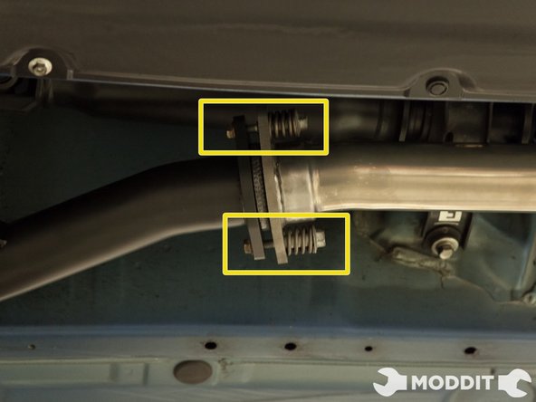 Near the rear of the car insert the hanger busing and insert the exhaust hanger. This positions acts as a pivot point to help position the exhaust and alleviate the weight