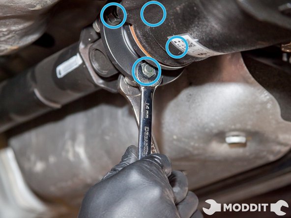 Remove the 4 nuts/bolts that attaches the driveshaft to the differential housing