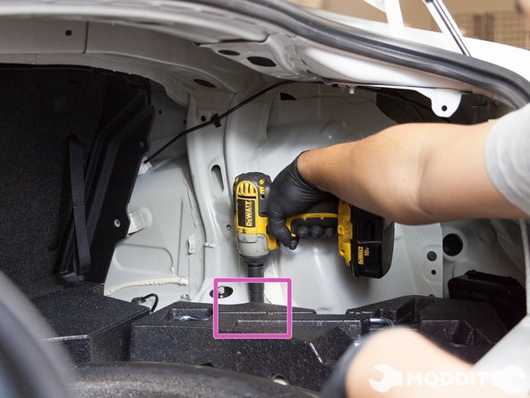 Because  the interior panels should already be removed, you can now remove the 14mm top hat nuts located in the trunk.