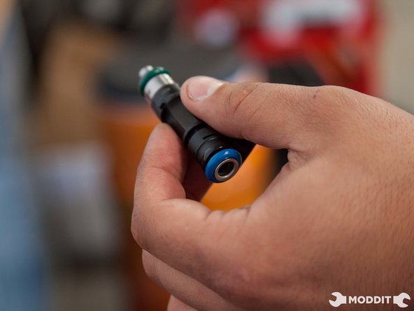 Dab the injector o-rings with oil or some sort of lubrication and carefully insert each one into the fuel rail.