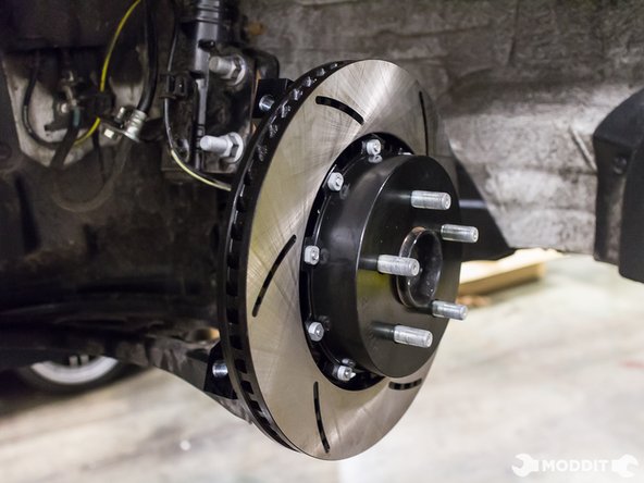 Install brake rotor onto knuckle. Brake rotors are directional so install them accordingly. Use Lug nuts to keep rotor flush to the hub.