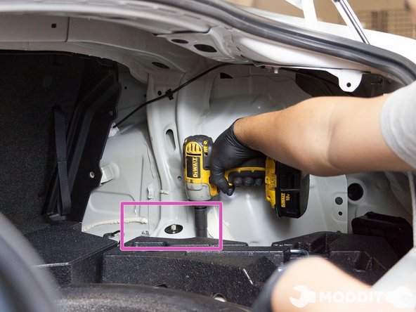 Because the interior panels should already be removed, you can now remove the 14mm top hat nuts located in the trunk.