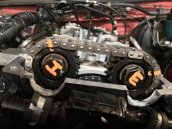 There will be small indentations / dimples on the chain to indicate the chains orientation. If you cannot see the dimples due to the use of an aftermarket chain kit, then mark the location of the dowel pins to the links.