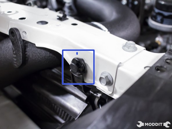 With the two remaining factory plastic clips, secure the Perrin Diverter bracket to the radiator support.