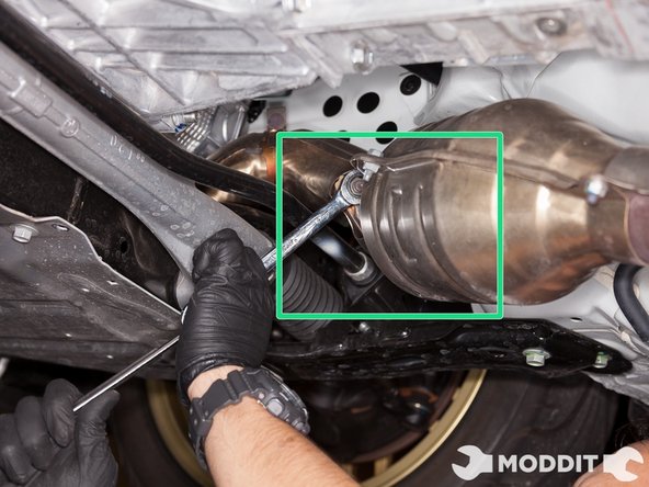 Using a 14mm wrench, remove the two nuts holding the frontpipe to the overpipe.